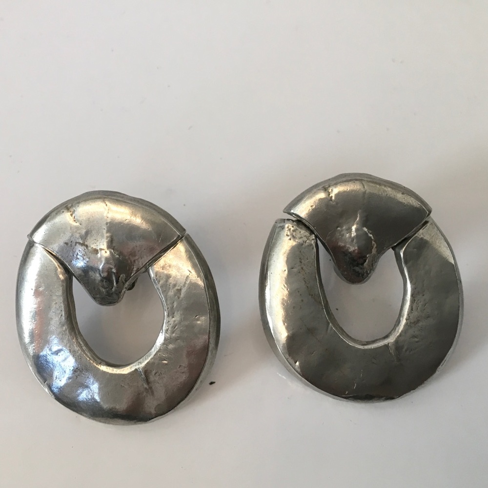 Vintage circle with hinged triangle Ciner clip-on earrings. White metal.  Silver